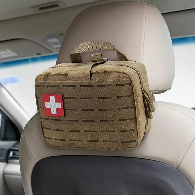 Khaki first-aid bag hanging on a car seat headrest